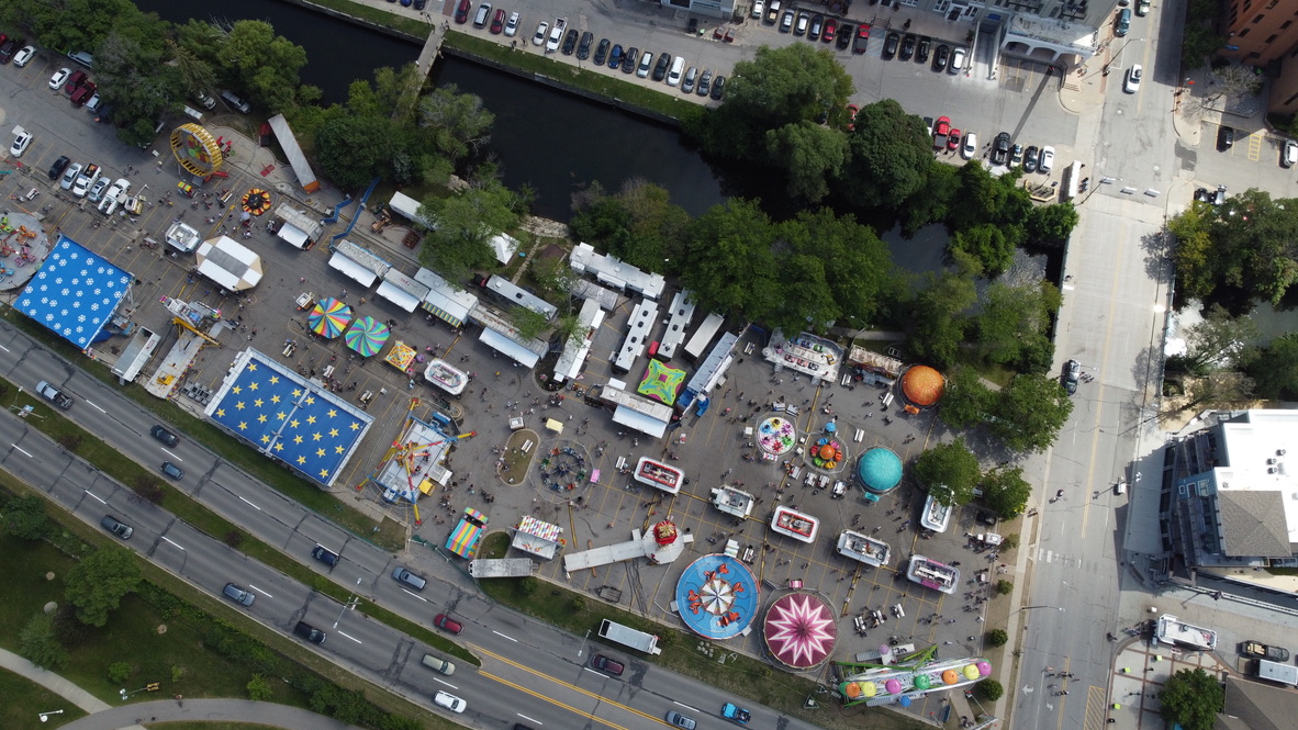 Aerial view of the Cherry Festival carnival midway and crowds along the Open Space in Traverse City