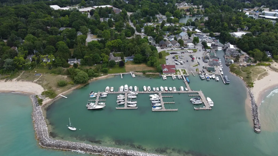 Aerial view of Fishtown harbor in Leland with boats and turquoise water