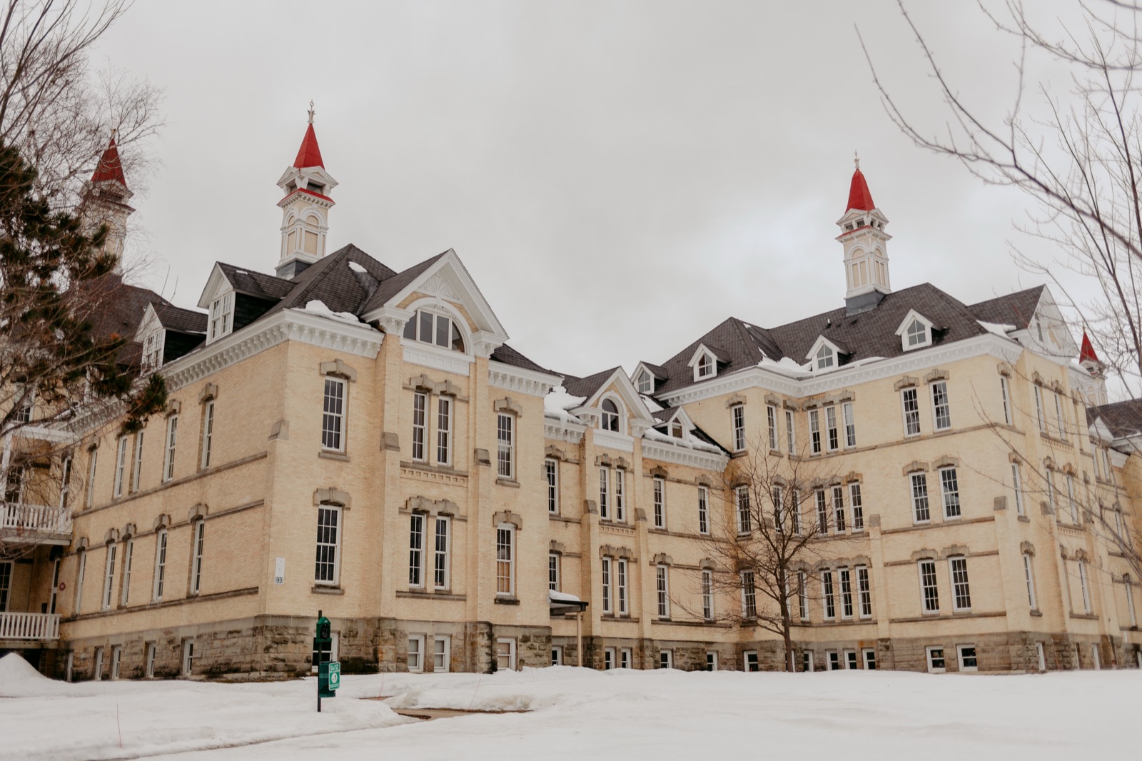 Historic Building 50 at the Grand Traverse Commons with its red spires under fresh snow in Traverse City